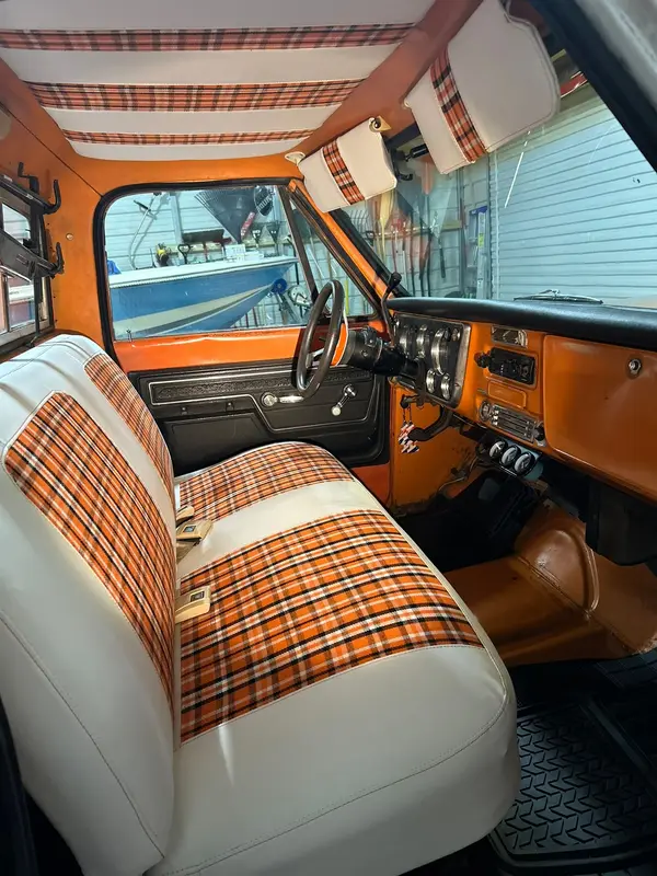 Bench seat from the passenger side with plaid inserts