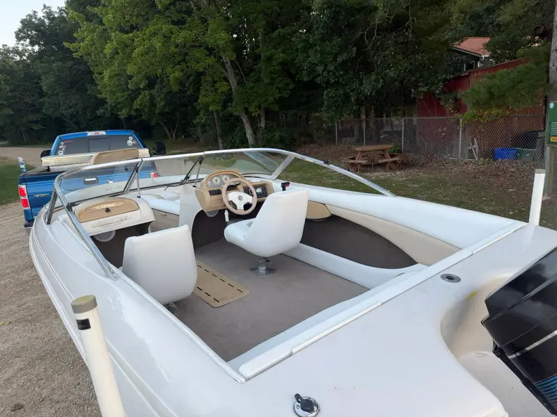Glastron interior from the stern, white seats and tan side panels