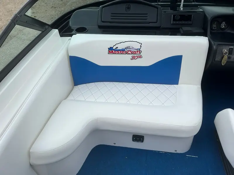 Corner lounge seat with a blue wave panel, MasterCraft 30th logo and diamond-stitched cushion