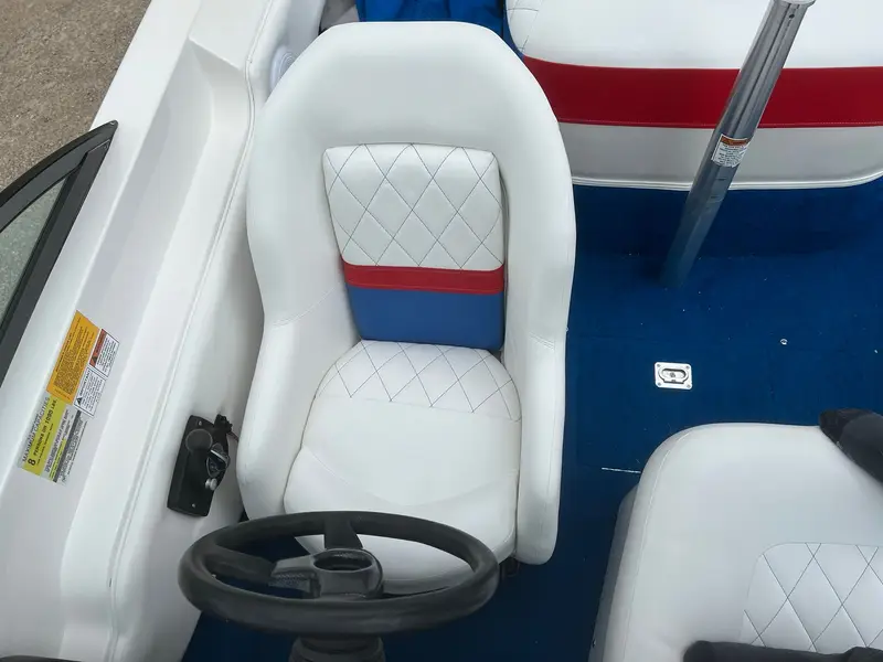 Driver's seat in white with diamond stitching and a red and blue band